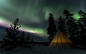 Illuminated teepee, tipi, tepee, Northern or Polar Lights, Aurora Borealis, green, pink, purple, near Whitehorse, Yukon Territory, Canada