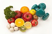 Fruit and vegetables with two dumbbells