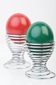 Red and green Easter eggs in eggcups