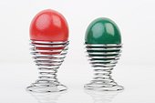 Red and green Easter eggs in eggcups