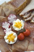 Easter snacks, snack plate with ham, sausage, vegetables and egg