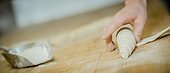 Baking rolls, hand shaping dough