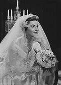Woman sitting in wedding dress, close-up