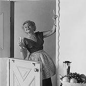 Woman holding measuring cup, portrait