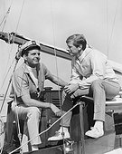 Two men talking in boat, smiling