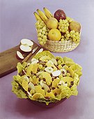 Fruit salad and basket against pink background,, close-up