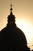 Rome, Italy.. The silhouette of a church dome at sunrise.