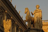 Rome, Italy.. Ancient statues stand in the sunset light.