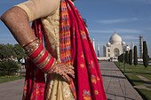 Agra, Uttar Pradesh, India.. An Indian woman, with henna on her hand and arm, visits the Taj Mahal.