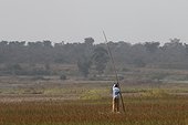 Ngaoundere Lake, Adamaoua, Cameroon.. A local fisherman uses a pole.
