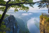 Germany, Saxony, Rathen, Elbe, Dawn on the Bastei rocks and the harbor of the village, along the Elba river, in background, view from Lohmen