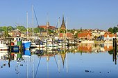 Germany, Schleswig-Holstein, Flensburg, im jaich yachthafen and yachts in the foreground with Flensburg old town and Sankt Marien kirche in the background.