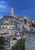 Italy, Basilicata, Matera district, Matera, Sassi di Matera, the typical districts of the old town carved out of the rocks. View of Sasso Barisano illuminated at dusk