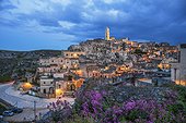 Italy, Basilicata, Matera district, Matera, Sassi di Matera, the typical districts of the old town carved out of the rocks. View of Sasso Barisano illuminated at dusk