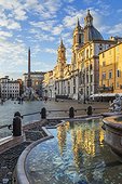 Italy, Latium, Roma district, Rome, Piazza Navona, Fountain of Neptune, Sunrise over Sant'Agnese in Agone church and Fountain of Four Rivers