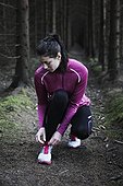 Woman runner tying shoelaces