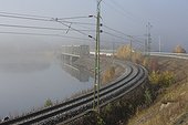 Train bridge and railroad tracks in fog