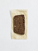 Directly above view of rye bread on paper, studio shot