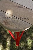Close-up of stool with text on it