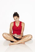 Woman in workout clothes with digital tablet on white background