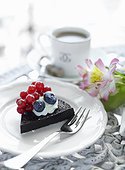 Piece of cake with berries on plate