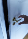 Hand reaching door knob, Vastergotland, Sweden