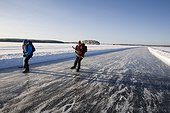 Two skiers on ice track