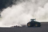 Tractor and dust on field