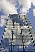 Glass exterior of hotel building against sky