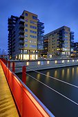 Illuminated residential structure and bridge at dusk