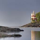 Scenic lighthouse on rocky sea shore
