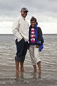 Portrait of couple wading in sea