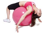 Young woman stretching on a fitness ball
