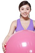 Young woman holding fitness ball