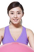 Young woman holding fitness ball