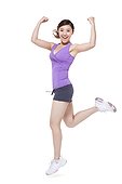 Young woman jumping with arms raised in excitement
