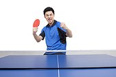 Table tennis player cheers with arm raised in triumph