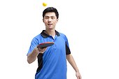 Table tennis player bounces ball on paddle