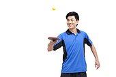 Table tennis player bounces ball on paddle
