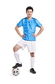 Soccer player with hands on hips smilng