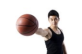 Man holding a basketball with one hand