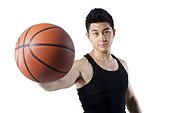 Man holding a basketball with one hand
