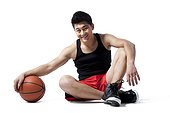 Man sitting on the floor with basketball