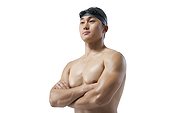 Muscular swimmer with arms crossed