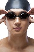 Swimmer with swimcap and goggles headshot