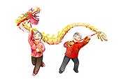 Senior couple playing Chinese dragon dancing