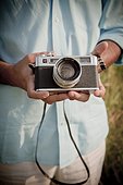 Close-up of Man holding Vintage Camera