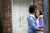 Portrait of Young Couple Embracing in Alleyway