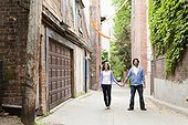 Portrait of Young Couple Standing in Alleyway, Toronto, Ontario, Canada