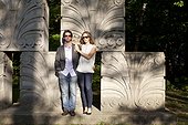 Portrait of Young Couple Standing in front of Stone Sculptures in Park, Ontario, Canada